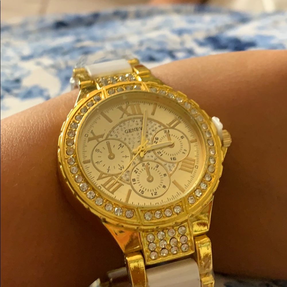 A gold watch with fake diamonds